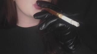 Smoking using a cigarette holder and wearing leather gloves