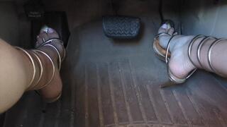 Fifi teasing and pumping the pedals before driving around in reveling gold heels that wrap up the leg