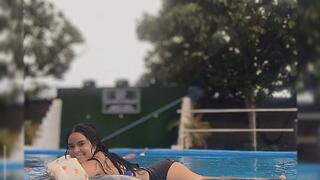 Pool toys and Carmen playing in the pool