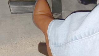 Evalynn driving in brown heeled boots