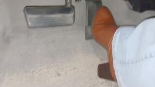 Evalynn driving in brown heeled boots 2