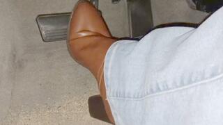 Evalynn driving in brown heeled boots 3