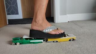 Nikkichick crushes 2 classic cars in flip flops with painted toe nails toy cars crush close ground view