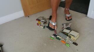 Nikkichick crushes buildings & many small cars in flip flops with painted toe nails toy cars crush low right view