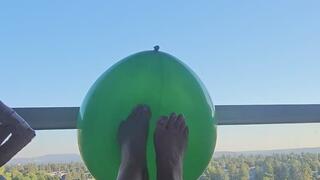 Playing footsies with a green balloon????
