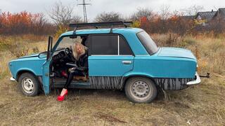 Anastasia revving old VAZ in her high heels and shiny outfit