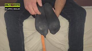 Tickling black socks on bed