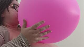 blowing pink balloon