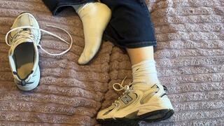 Anthony removes Amelie’s sneakers while she is resting