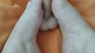 Caresses feet with oil footjob