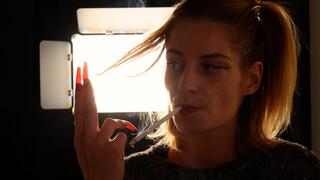 Eve’s elegant long-cigarette smoking tease and striking red nails