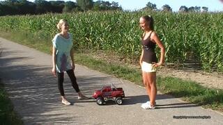 two girls crush a big toycar