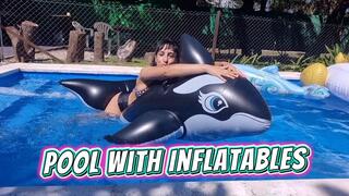 Alesia having fun in the pool with inflatables