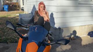 Alice smokes a cigarette while posing on her motorcycle (4k)