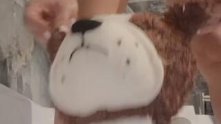 My big plush dog is peeing directly in his mouth.