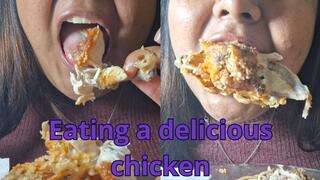 Devouring pieces of fried chicken with his hands