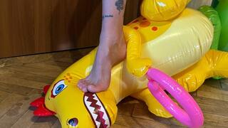 Nastya, barefoot and wearing beautiful black panties, sits on inflatable dinosaurs, sits on their faces, steps on them, tramples them, and walks on them. foot fetish, trampling, and barefoot