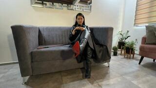 Kalinda smokes while dressed in leather