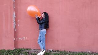 Playing with a red balloon outdoors - Mishel Looner Balloons