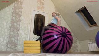 Alla happily jumps high on two large inflatable balls and pumps them with her mouth.