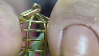 A gothic giantess teases a tiny slave that sits in a cage