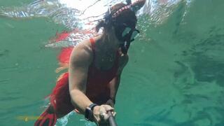 Carissa snorkeling in her Christmas outfit with exposure part two