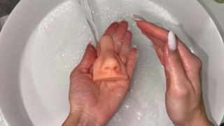 Nastya washes a toy rubber nose