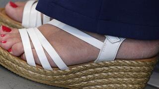 Hot foot fetish admiration. Cute toes and red polish nails, suckable sexy heel with sandals, skin feet over view