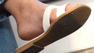 Foot and shoe fetish admiration, dirty feet and slippers dangling close-up, hot feet.