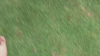 Woman with sensual feet walks barefoot on the grass