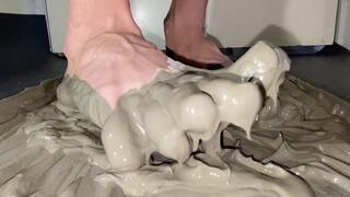 Bare feet mixing wet cement