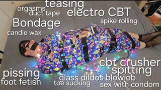 Slave toy Wolfy01 as a holiday present bondaged in paper with duct tape and colourful lights for his Mistress GospodaricaEmma