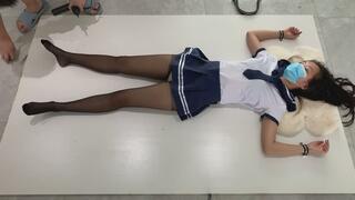 Black stockings schoolgirl fixed on wooden board for discipline