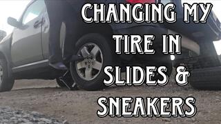 Changing my tire in flats and sneakers
