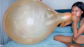 Sexy Camylle Blows To Pop Yoiur Huge Orange Belbal 24 Inch Balloon In A Green Bikini