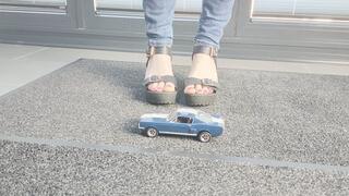 Ground view Abby Giantess crushing a 1966 Shelby Boss Mustang in black platform high heels