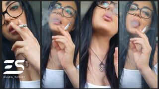 A car smoke in a Summer top and glasses