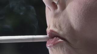 Profile view up close holding a VS 120 in my mouth w blue glasses