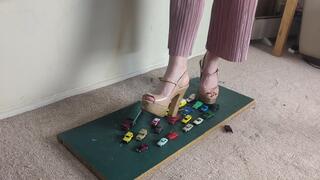 Giantess Lily Kink toy car crush of many tiny cars in big chunky heels high left view