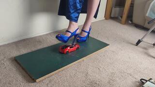 Giantess Lily Kink toy car crush of a 2017 BMW I8 in big blue heels Left view