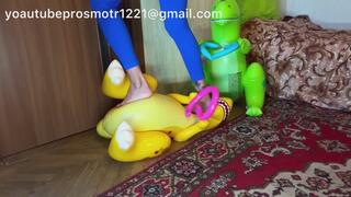 Nastya tramples on inflatable dinosaurs with her bare feet, destroying their weight. Crush fetish Foot fetish