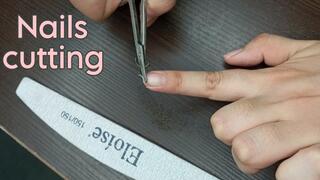 Fingernails cutting with scissors and nail file