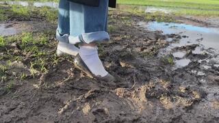 Amelie get her ballet flats and white socks muddy in a field