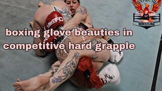Strong tattooed girls wrestle in boxing gloves