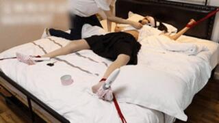 GG38 - Cute Asian girl in short skirt and stockings is bound to the bed and tickled.