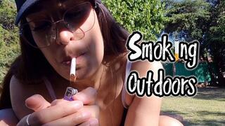 Alesia in a bikini, smoking sexily outdoors