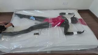 Latex ballet shoe doll in a vacuum bed