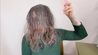 she is brushing her natural wet hair