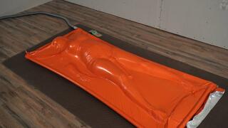 Adventurer finds herself trapped in an orange vacuum bag orgasm