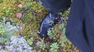 Wet rubber boots walking in forrest